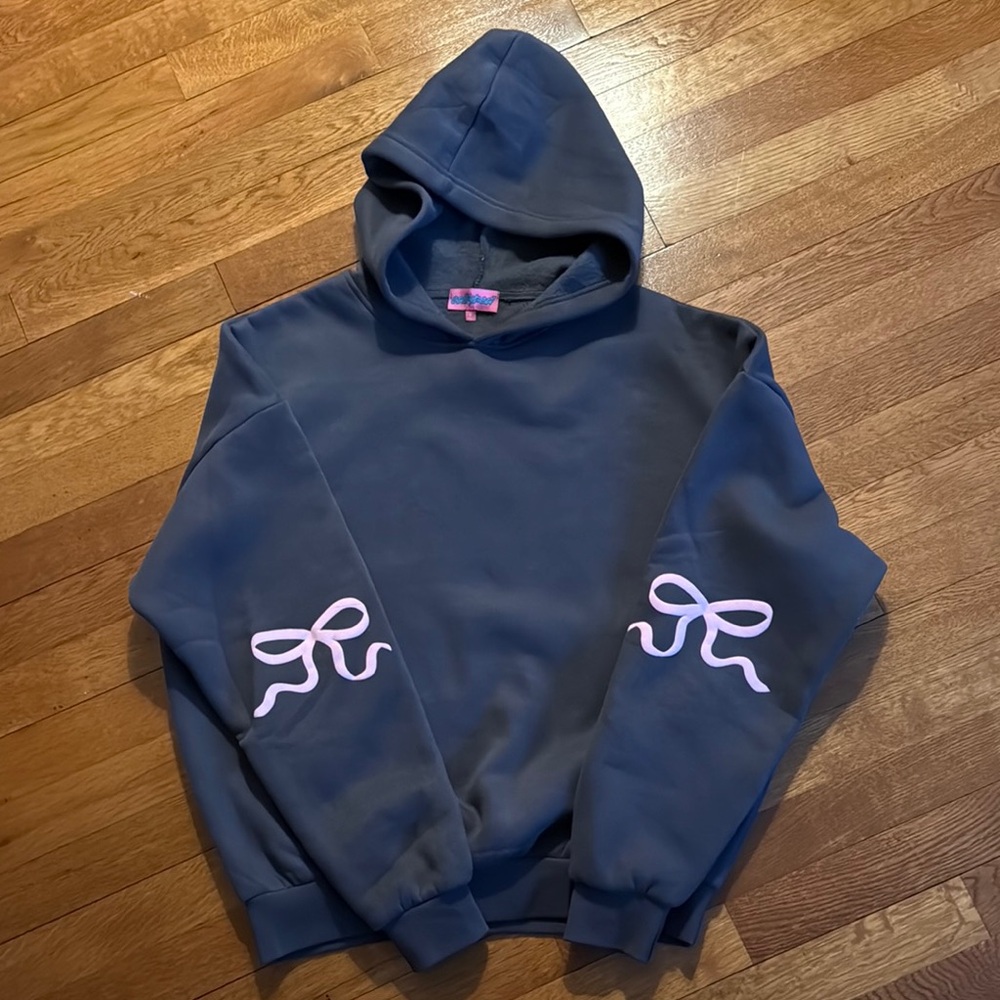 EDIKTED hooded sweatshirt. Dark gray with pink bows located back of sleeve.